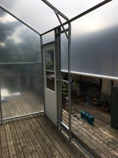 small-backyard-greenhouse-construction.jpeg